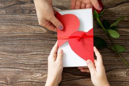 The child gives Mother’s Day or Valentine’s Day gift – card heart. Handmade. The child gives Mother's Day or Valentine's Day gift - card heart. Handmade.
